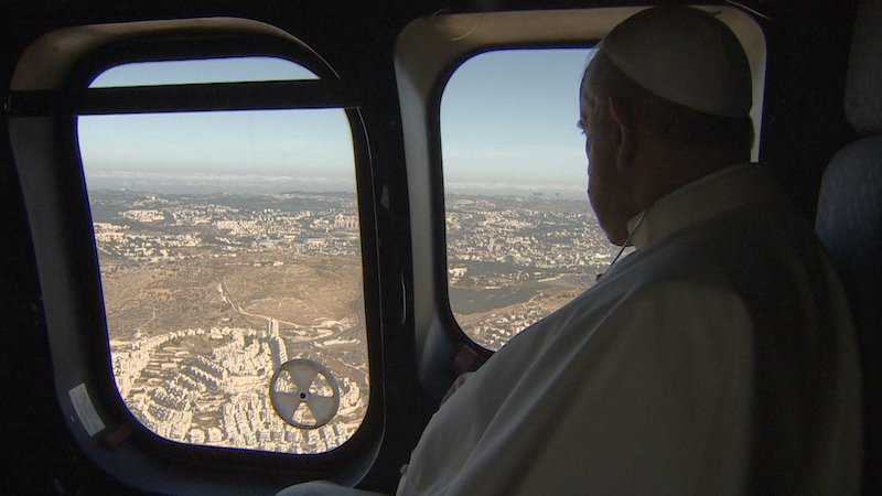 Pope Francis looking out his plane window in In Viaggio documentary.